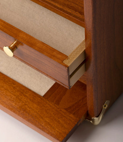 Close-up of the Best Made Co. Gerstner 41D Founder’s Edition, a wooden machinist chest with a polished American cherry finish, gold metal hardware accents, partially opened drawer with a gold knob and beige interior.