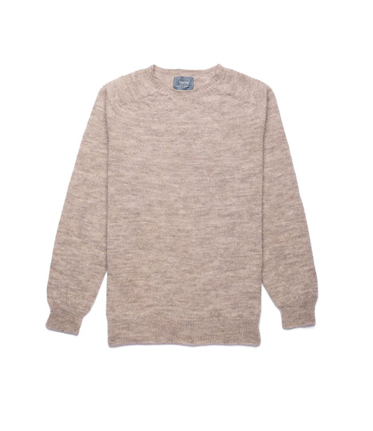 A man with short light brown hair and a mustache stands indoors, arms crossed, wearing the Best Made Co. 5-Gauge Shetland Sweater over a blue collared shirt and dark jeans, in front of wooden paneled walls.