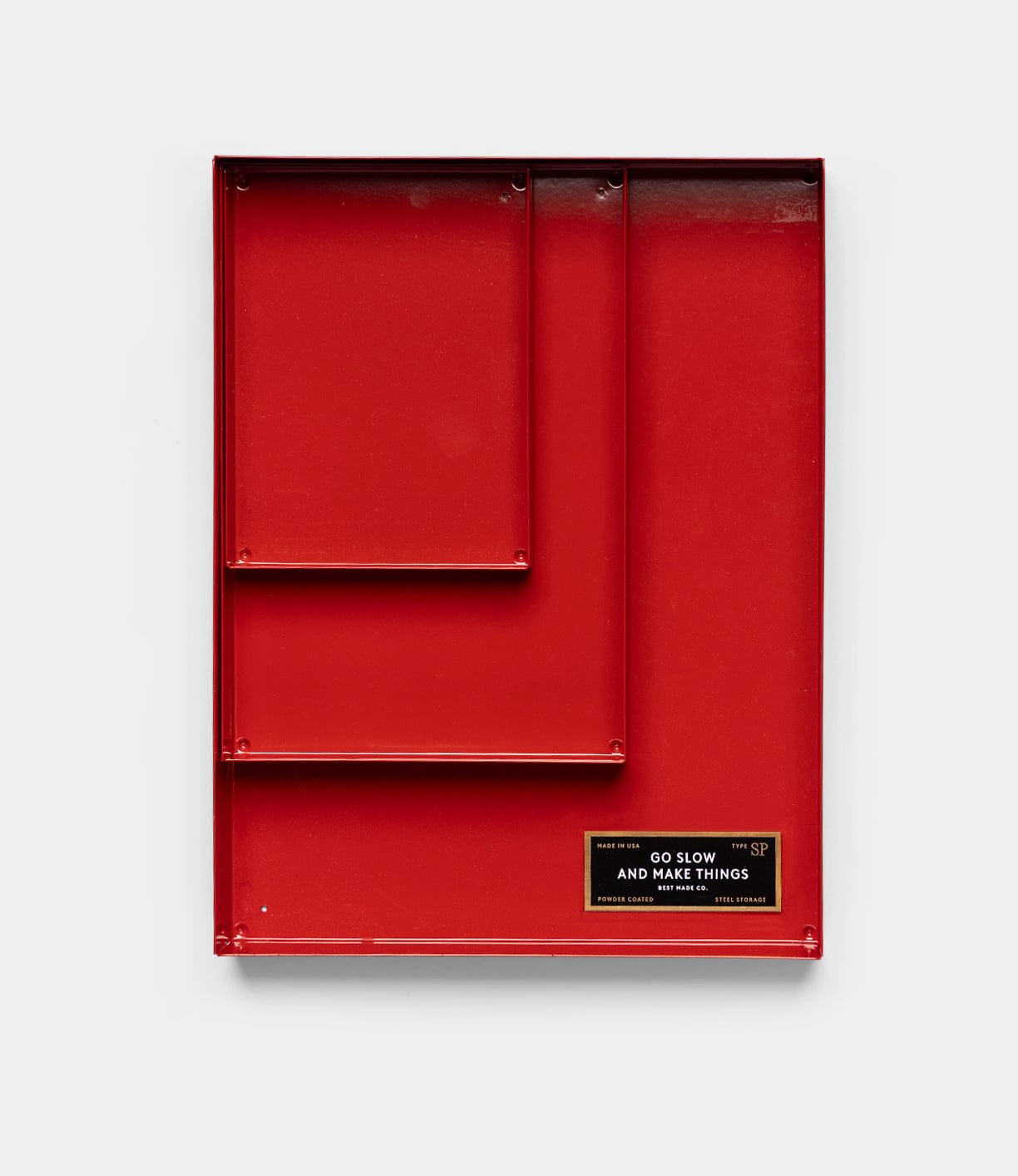 The Spare Parts Trays (Set of 3), Go Slow Edition by Best Made Co is a red, rectangular steel wall organizer featuring three compartments and a black "GO SLOW AND MAKE THINGS" plaque on the bottom right, set against a plain white background.
