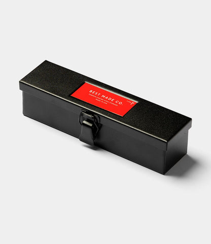 The Best Made Co. Type P Strongbox in matte black—a rectangular steel pencil box with a latch and red "Best Made Co." label—demonstrates the brand’s signature durability.