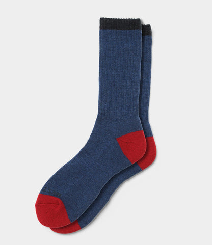 Best Made Co. Japanese Wool Socks in blue feature black cuffs with red heels and toes, shown stacked neatly on a plain white background—ideal for cold weather wear.