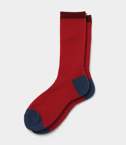A pair of Japanese Wool Socks by Best Made Co.—red with dark blue toes and heels plus a deep red cuff—laid flat on a white background; the ideal cold weather footwear.