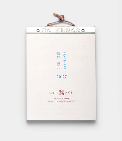 A hanging Himekuri Calendar 2027 traditional Japanese tear-off calendar with CALENDAR at the top, featuring the text STAY SHARP, 20 27, and a logo with two crossed bandages.