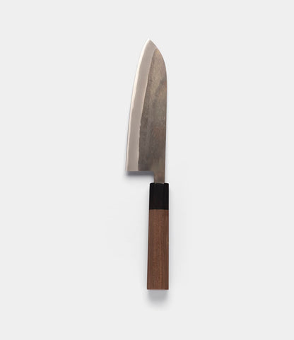 The Best Made Co. Aogami Santoku Knife features a wide Blue Paper Steel blade and a wooden handle, shown against a plain light gray background.