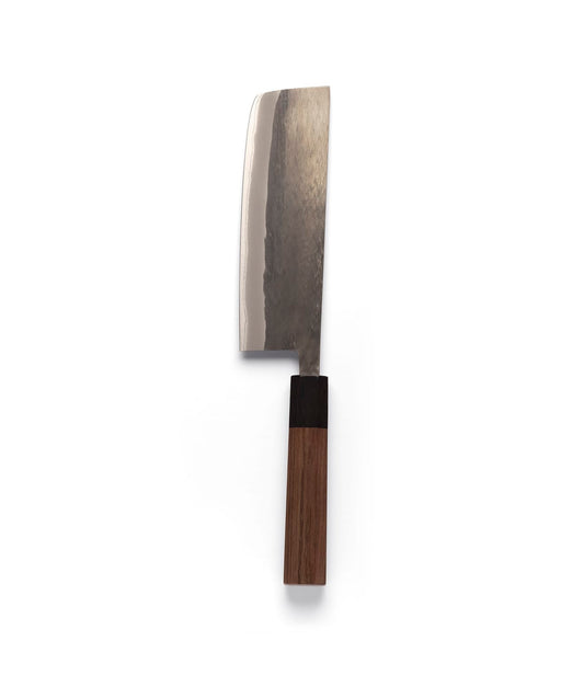 The Best Made Co. Aogami Nakiri Knife, crafted from Blue Paper Steel No. 2, features a flat-edged, dark-textured steel blade and a cylindrical wooden handle with a dark bolster, presented vertically against a plain light gray background.