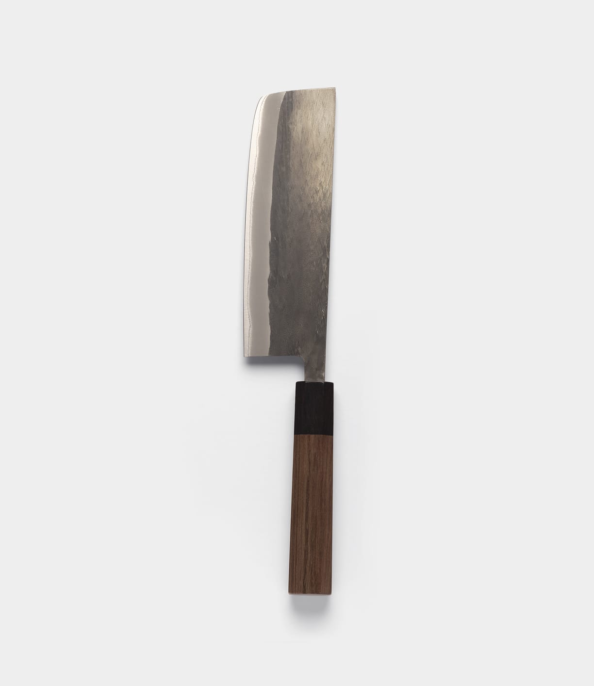 The Best Made Co. Aogami Nakiri Knife, crafted from Blue Paper Steel No. 2, features a flat-edged, dark-textured steel blade and a cylindrical wooden handle with a dark bolster, presented vertically against a plain light gray background.