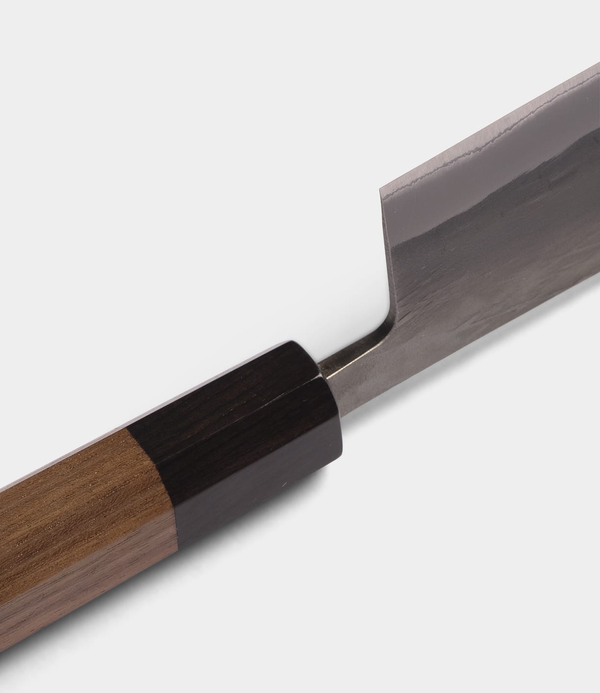 Close-up of the Best Made Co. Aogami Nakiri Knife, featuring a wooden handle and a shiny, rectangular Blue Paper Steel No. 2 blade, set against a plain white background.