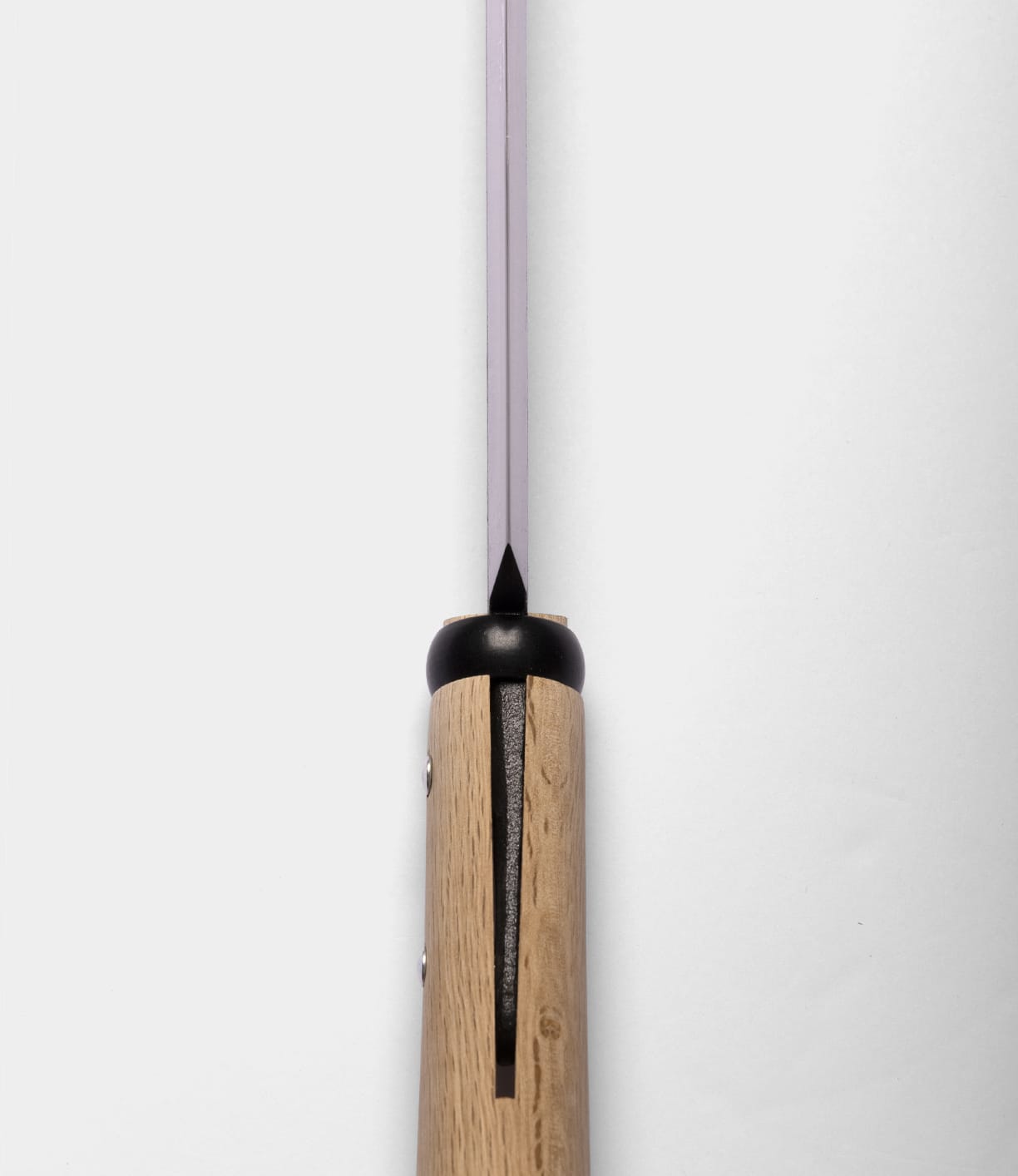 Close-up of the top view of a Best Made Co. Sayanata Hatchet handle made of wood with a visible slot, metal rivets, and a thin Nippon carbon steel blade extending upward against a plain white background.