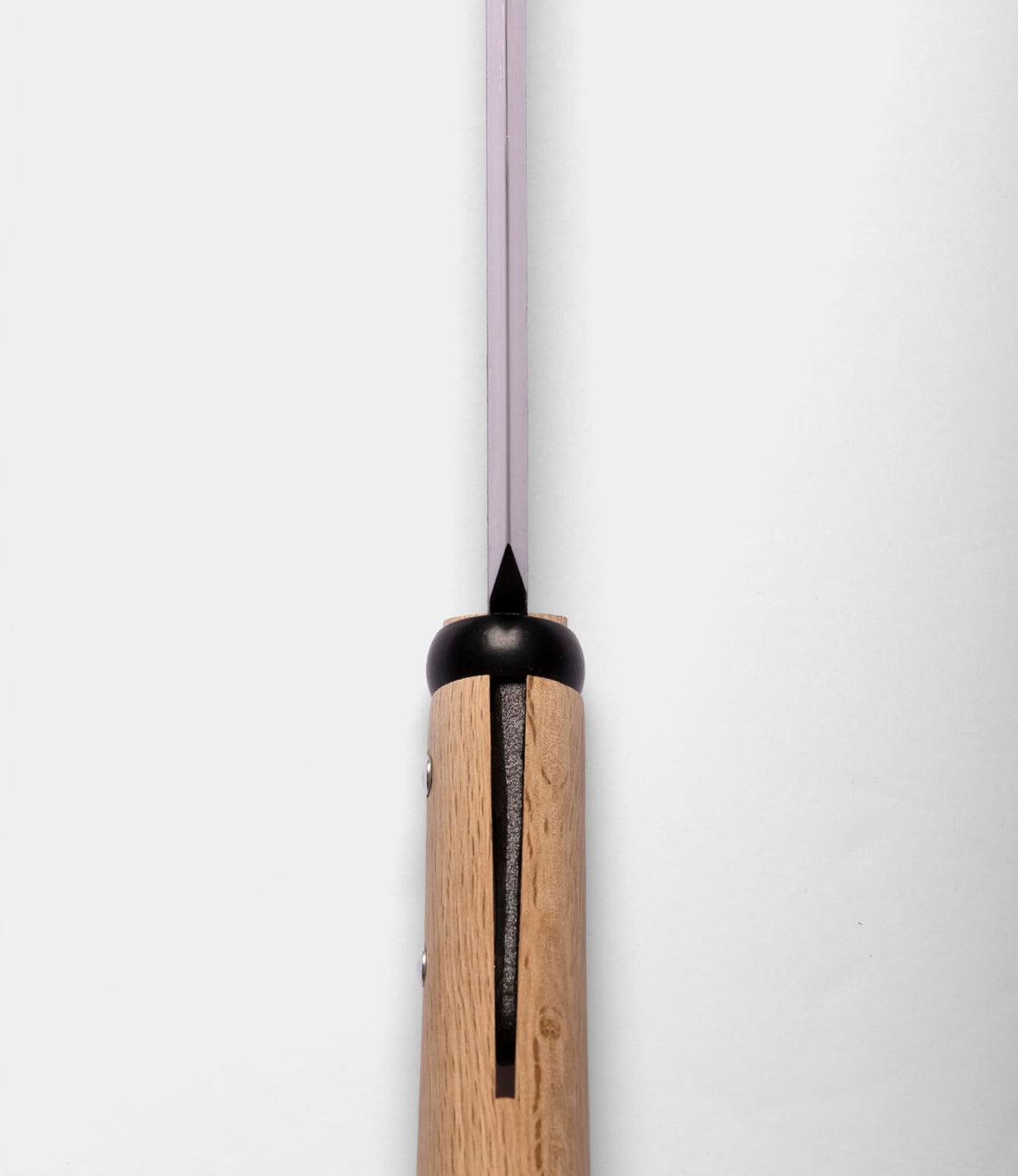 Close-up of the top view of a Best Made Co. Sayanata Hatchet handle made of wood with a visible slot, metal rivets, and a thin Nippon carbon steel blade extending upward against a plain white background.