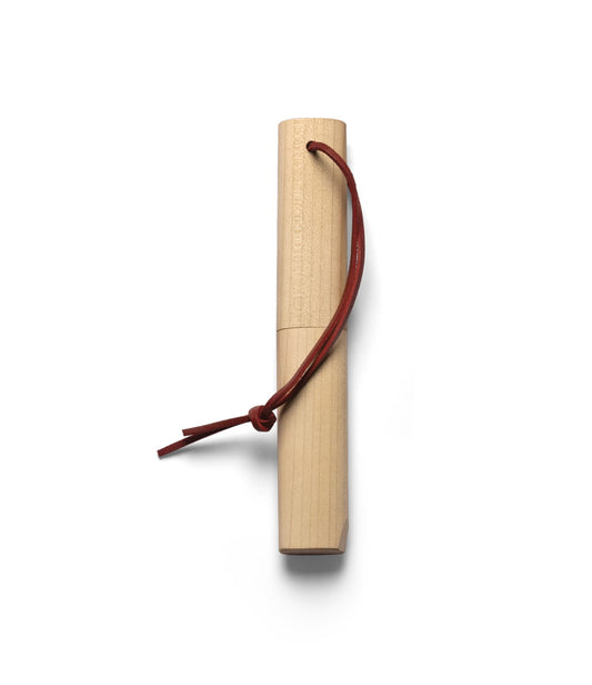 The Best Made Co. Kiridashi Knife, featuring a wooden handle and red leather strap, is shown with its sheath removed and placed beside the single-bevel blade on a plain white background.