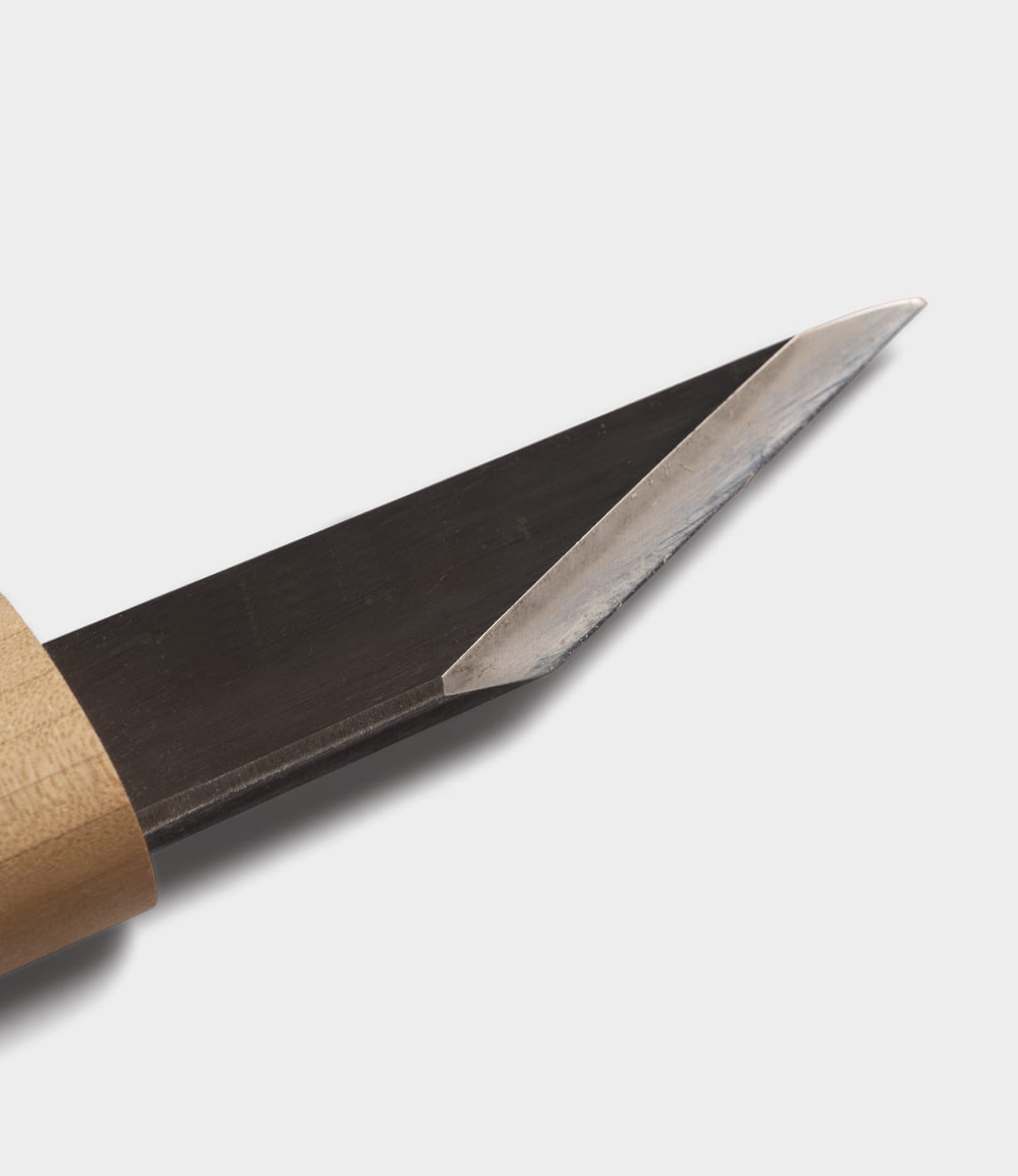 Close-up of the Best Made Co. Kiridashi Knife, featuring a wooden handle and sharp, pointed single-beveled edge set against a plain white background.