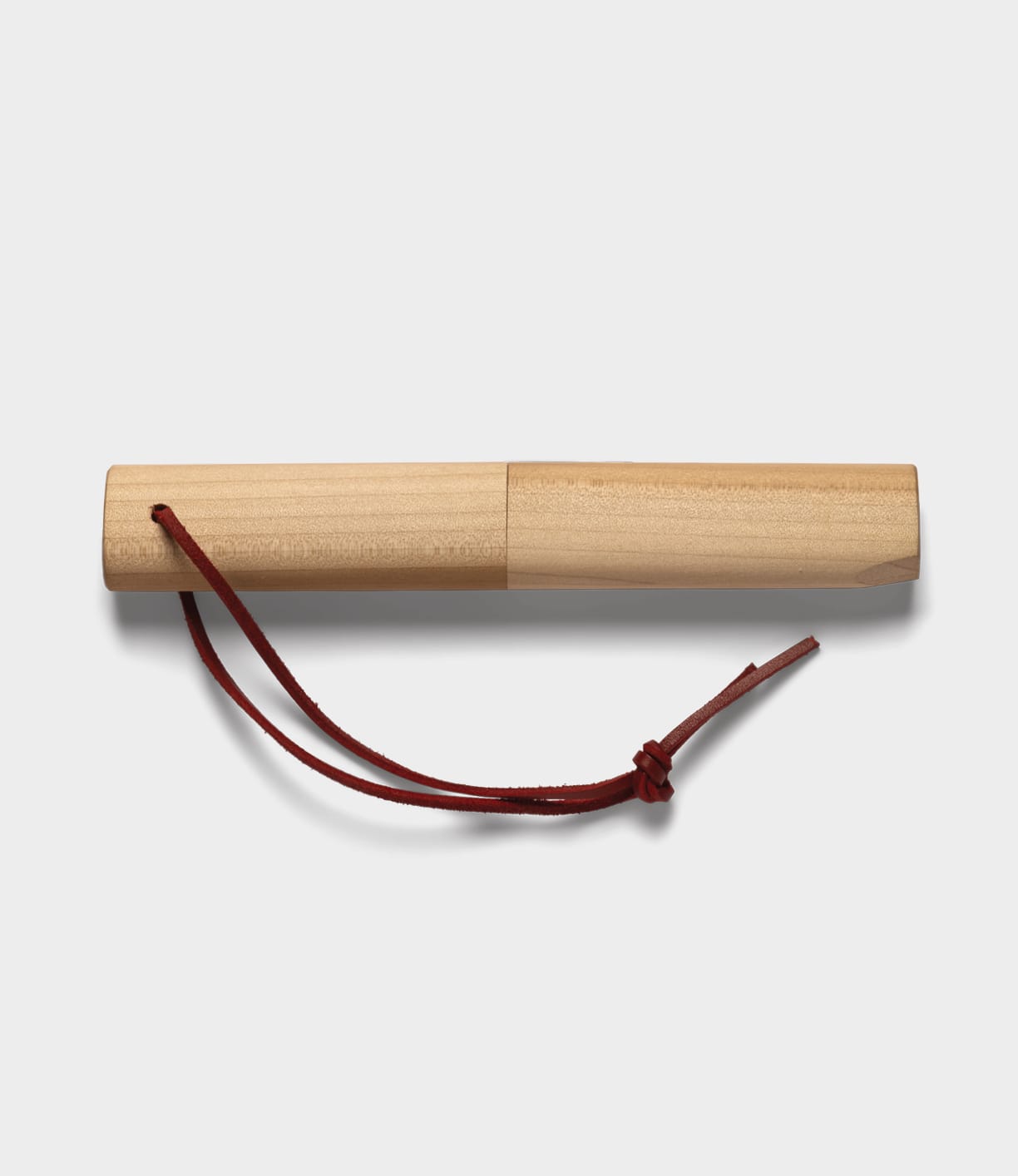 A smooth cylindrical wooden case with a lid and red leather strap, designed by Best Made Co. to hold a Kiridashi Knife, is displayed against a plain white background.