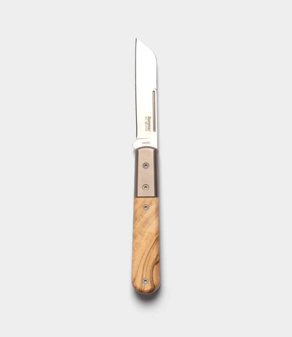 The Best Made Co. Italian Barlow showcases a straight-edged M390 stainless steel blade and light wood handle, pictured open on a plain, light gray background.