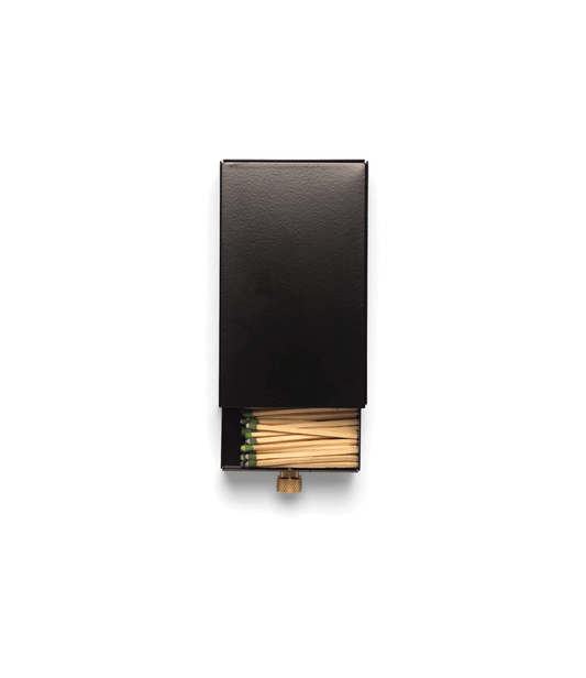 Best Made Co. Sliding Match Safe Black, partially open to reveal green-tipped strike-anywhere matches inside the black metal case.