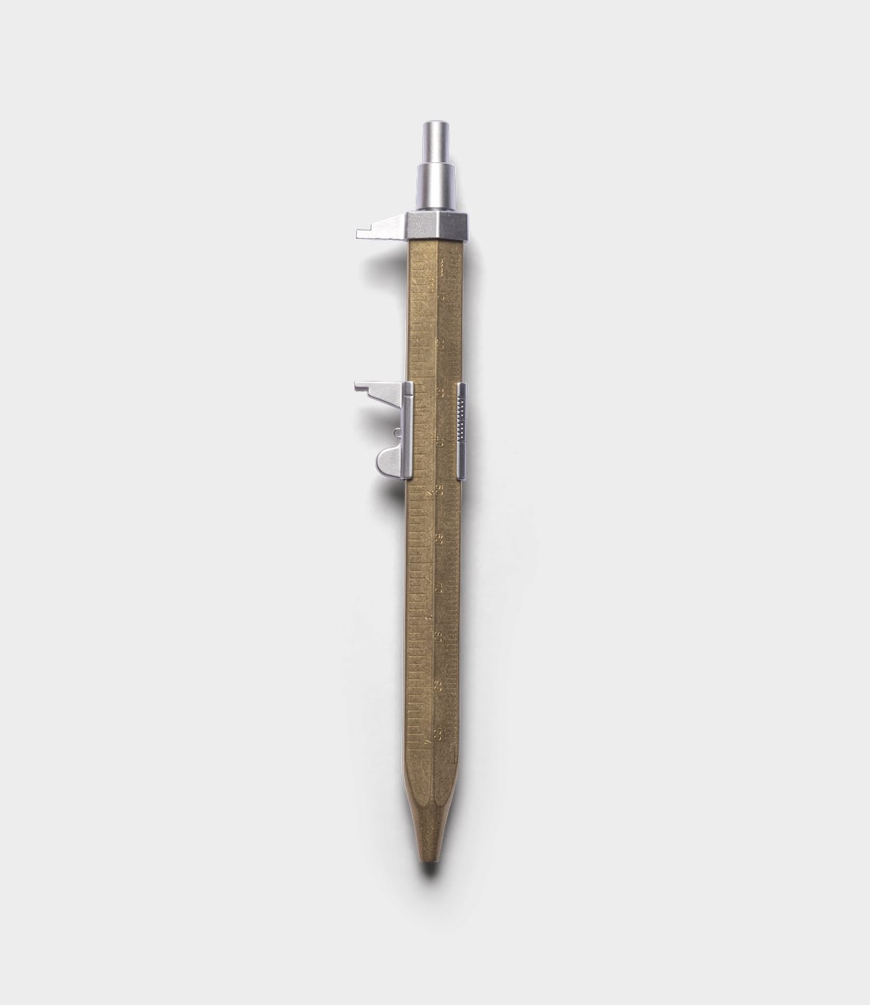 The Best Made Co. Brass Messograf Pen, with its industrial design, metal clip, and knurled push button, stands vertically against a plain light gray background.