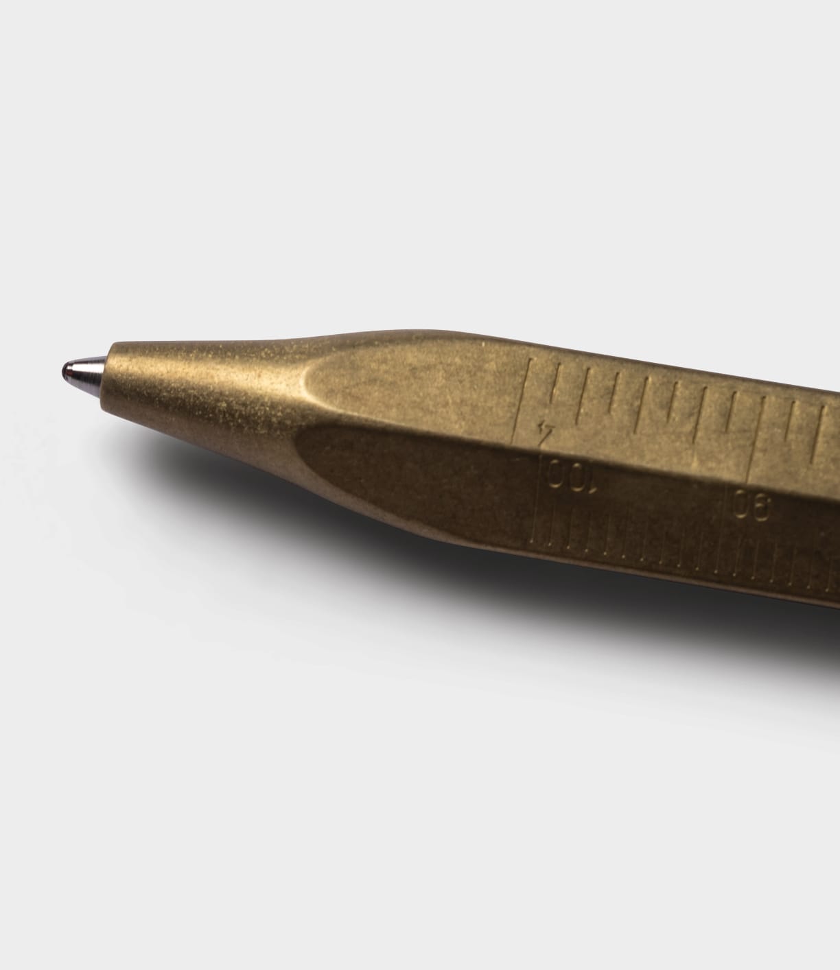 A close-up of the Brass Messograf Pen by Best Made Co., showcasing its precise measurement markings along the brass body, set against a plain light gray background.
