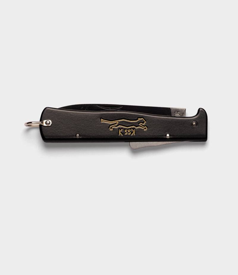 A closed K55K Mercator knife by Best Made Co. featuring a gold running cat and "K 55K" on the handle, displayed on a plain light gray background.