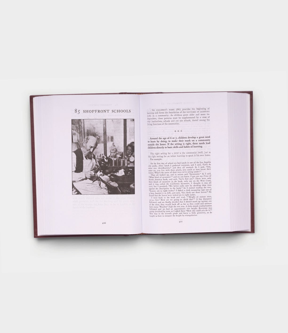 An open copy of Best Made Co.'s "A Pattern Language" displays a black-and-white photo of people working at a table on the left and text under the heading Shopfront Schools on both pages.