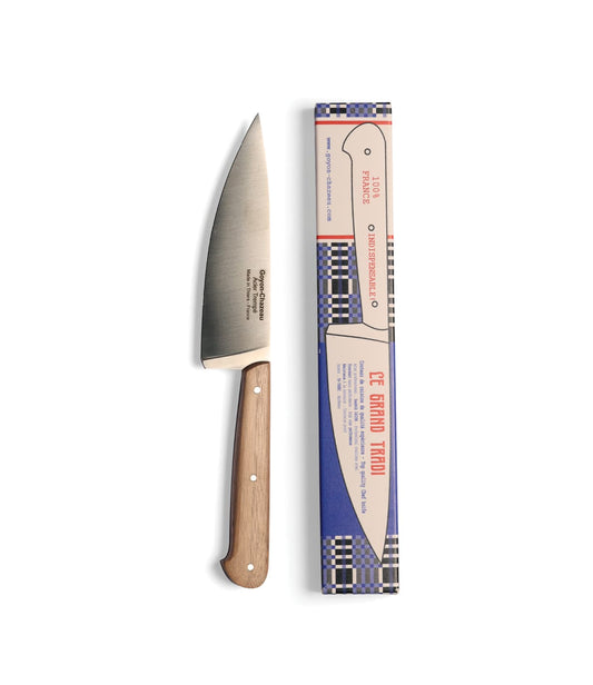 A Le Grand Tradi chef’s knife with a wood handle, shown with its rectangular product box featuring checkered trim.