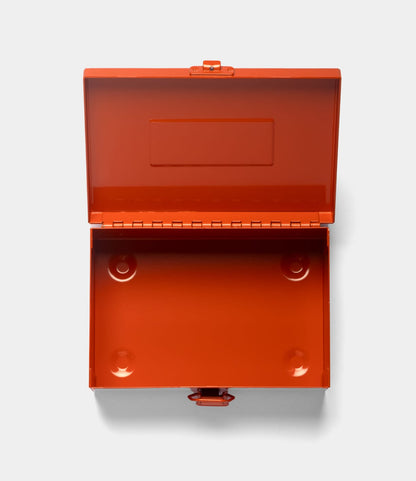 The Best Made Co. Type 6 Strongbox Orange is an empty, rectangular American steel box with a hinged lid and front latch, shown open from above against a light gray background.