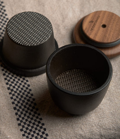 A Best Made Co. Cast Iron Grinder featuring a two-piece cast iron mill with a textured interior and a walnut lid.
