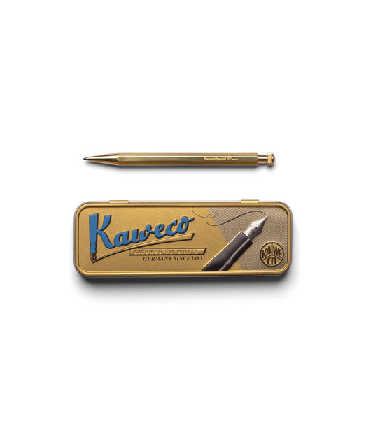 The Best Made Co. Kaweco Special, a gold octagonal mechanical pencil, rests on a wooden surface beside a metal ruler marked in centimeters and millimeters, and a brass latch plate.