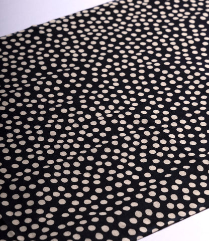 The Arare Tenugui by Best Made Co. is a black fabric inspired by wabi-sabi, featuring off-white irregular dots for a dynamic, modern look that embraces imperfect beauty.