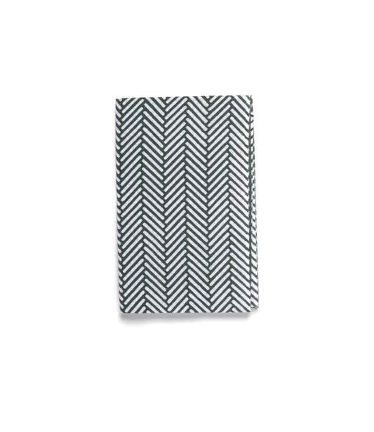 The Sugi-Aya Tenugui by Best Made Co. is a folded, hand-dyed Japanese cloth with a white background and dark green herringbone pattern, crafted using the traditional chusen technique.