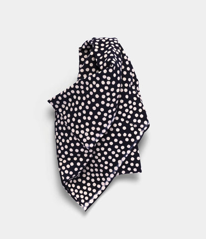 The Arare Tenugui by Best Made Co. is a navy blue, hand-dyed Japanese cloth featuring white polka dots, made using the chusen technique and shown loosely folded on a light gray background.
