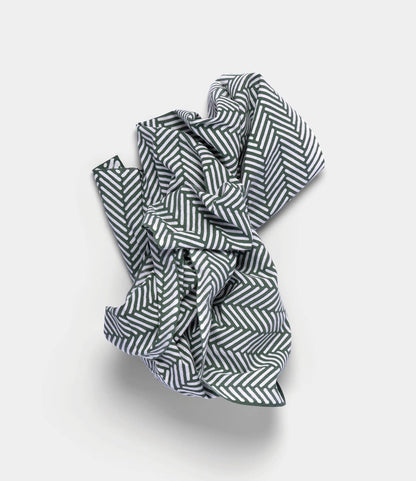 The Sugi-Aya Tenugui by Best Made Co., featuring a hand-dyed black and white herringbone pattern, is crumpled on a plain light background.