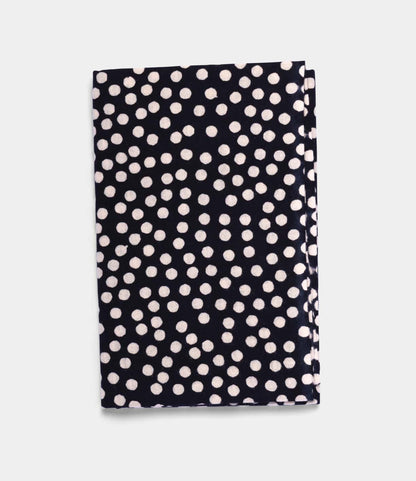 The Arare Tenugui by Best Made Co., a hand-dyed Japanese cloth with a black background and white polka dots crafted using the chusen technique, is shown folded on a plain light grey surface.