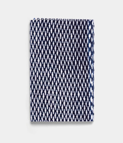 The Ami Net Tenugui by Best Made Co. is a folded rectangular Japanese tenugui with a white background and repeating navy blue diamond mesh pattern, crafted using the traditional chusen technique.