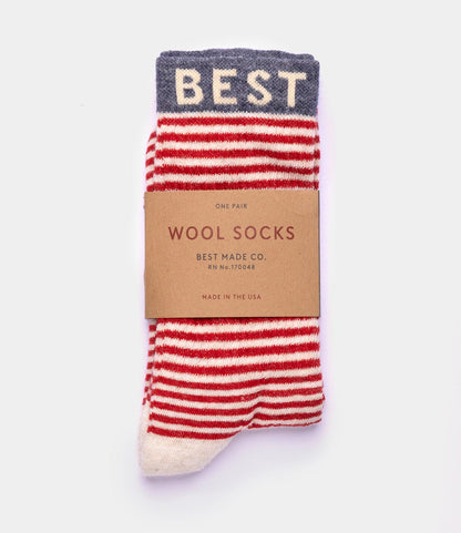 Experience all-season comfort with Best Made Co.'s Standard Wool Socks—red and white striped merino wool, gray cuff with “BEST” in white, wrapped in a brown label reading "WOOL SOCKS, Best Made Co., Made in the USA.