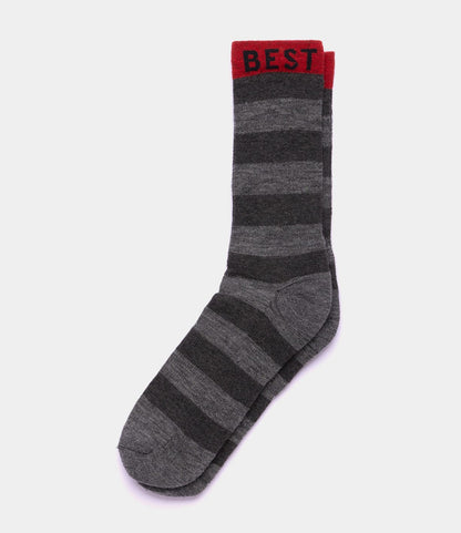 The Best Made Co. Standard Wool Sock is a single grey merino wool sock with dark grey stripes and a red cuff, featuring "BEST" in black letters for all-season comfort.