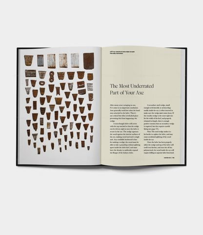 An open book—Buchanan-Smith’s Axe Handbook (signed) by Best Made Co.—shows axe head photos on the left and an article titled The Most Underrated Part of Your Axe on the right, reflecting Best Made’s signature style.