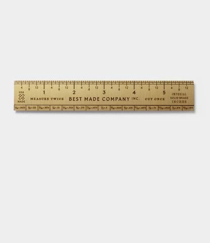 The Best Made Co. Measure Twice 6 inch Solid Brass Ruler is a precision tool made in the USA, with engraved inch and fractional markings on a white background and "Measure Twice Cut Once" text.