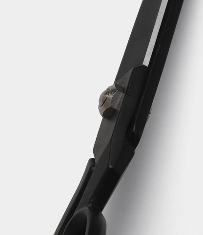 Close-up of the joint and blade edge of Best Made Co. Kevlar Shears, highlighting the screw holding the black industrial blades together against a plain white background.