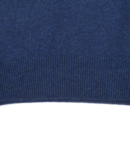 Close-up of the Lightweight Shetland Sweater by Best Made Co., showing dark blue lambswool and ribbed hem detail, crafted by Scottish woolen mills.