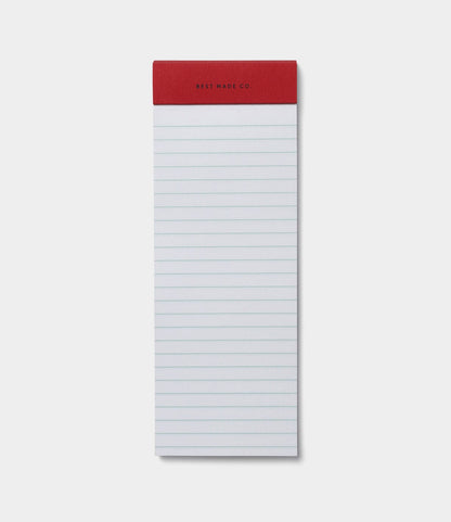 The S.B.T. List Pad by Best Made Co. is a portable, vertically oriented notepad with a red top binding, blank pages, and is ready for your notes or reminders.