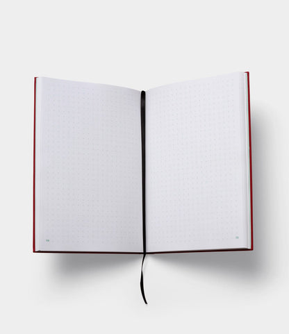 The S.B.T. Mid Cloth-Bound Notebook by Best Made Co. features a red cover, numbered dotted pages, and a black ribbon bookmark, ready for your writing or drawing on a white background.