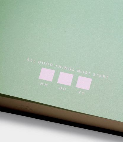 The Best Made Co. S.B.T. Mid Cloth-Bound Notebook features a green cover with "ALL GOOD THINGS MUST START:" in white above labeled boxes for MM, DD, and YY to enter the date.
