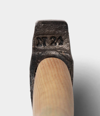 Close-up of the Old Gold No. 1 axe by Best Made Co., featuring a high-carbon steel head stamped with "N 24" and a wooden handle, set against a plain light background.
